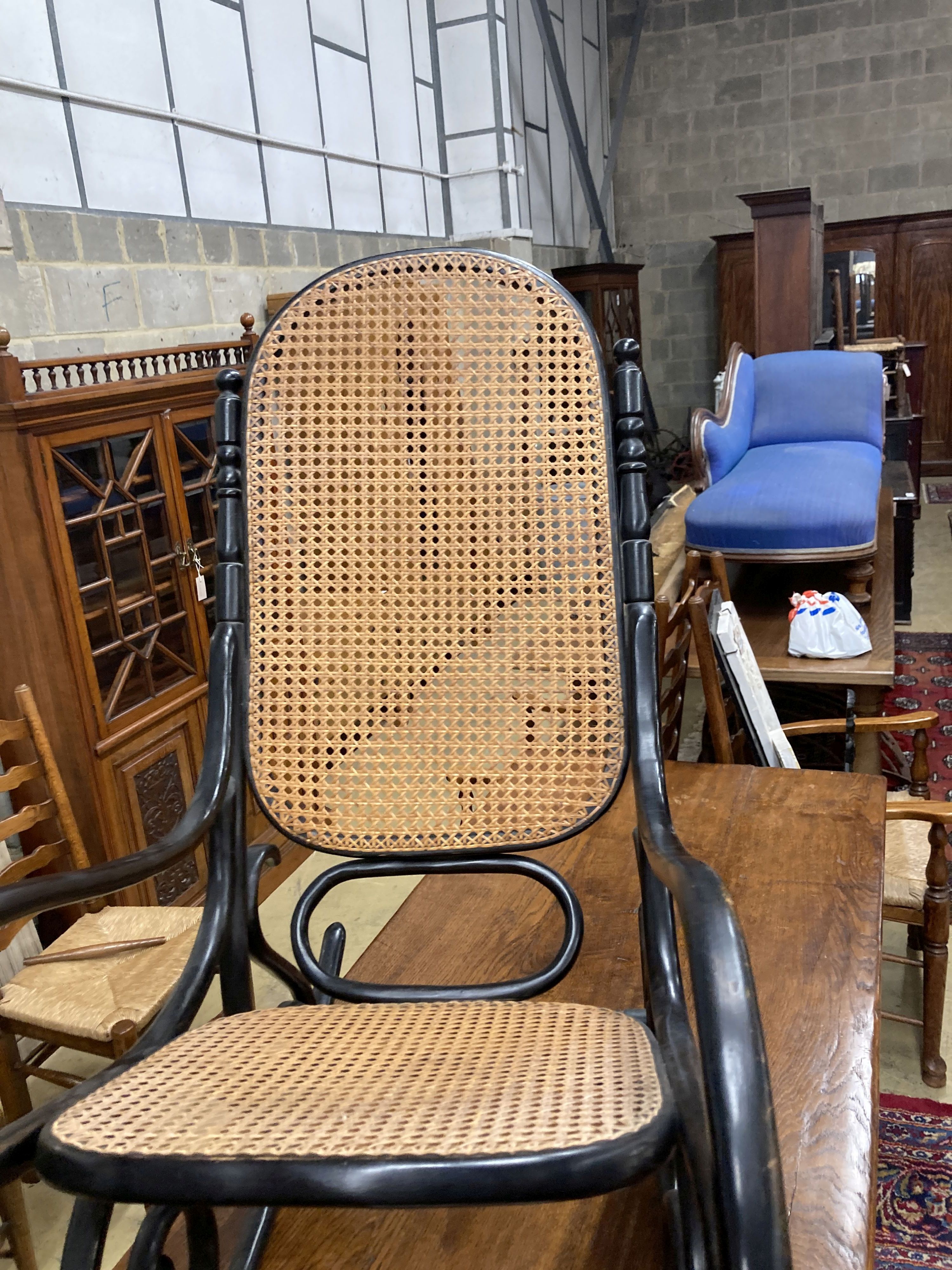 A Habitat 1970s ebonised bentwood caned rocking chair, width 50cm, depth 106cm, height 107cm